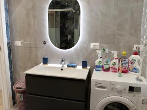 a bathroom with a sink and a washing machine at Sun House in Montesilvano +19 photos
