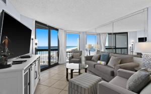 a living room with a couch and a television with a view at SunDestin Resort Unit 0814 in Destin