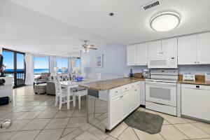 a kitchen with white cabinets and a dining room at SunDestin Resort Unit 0814 in Destin