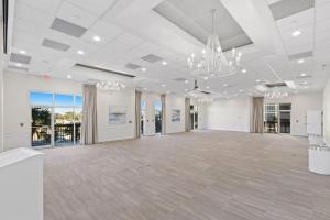 a large room with white walls and a ceiling with chandeliers at SunDestin Resort Unit 0814 in Destin +43 photos