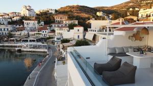 a balcony with a view of a city and water at Batsi Bay Loft in Batsi