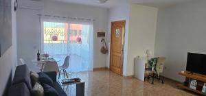 a living room with a couch and a table at Ático carrizal in Carrizal