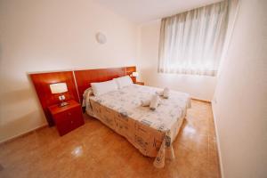 una camera da letto con un letto con un orsacchiotto sopra di Ático Dúplex con piscina Marcolina ad Alcossebre