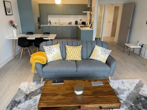 a living room with a couch and a kitchen at Waterside Athlone Apartment in Athlone
