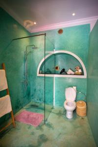 a bathroom with a toilet and a glass shower at Riad Bab Ahmar in Marrakesh
