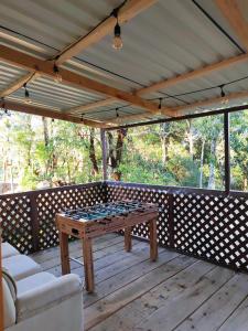 a wooden deck with a table and chairs on it at Cabaña Lugar de Paz in División
