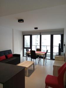 a living room with a couch and a table at Edificio Grimm in Puerto Madryn +39 photos