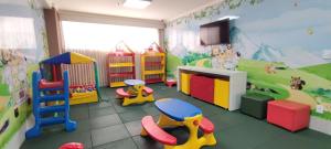 a childrens play room with toys and a tv at Spazzio diRoma com acesso ao diRoma Acqua Park - Via Caldas in Caldas Novas +11 photos