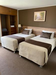 a hotel room with two beds in a room at Villa San José in Arequipa