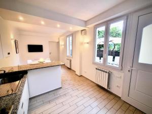 a kitchen with a counter and a window at Sanremo Suite Apartment in Sanremo