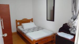Postel nebo postele na pokoji v ubytování Hostal Casa Primavera