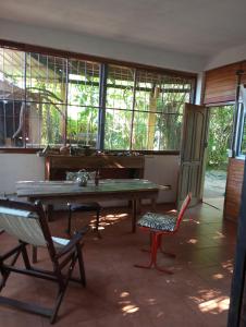 a room with a table and chairs and a piano at Scenario Yguazu in Puerto Iguazú
