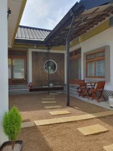 a patio with a pergola on a house at Hanok Stay Ohneul in Gyeongju