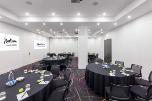 a conference room with tables and chairs in it at Radisson On Flagstaff Gardens Melbourne in Melbourne