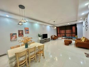 a dining room and living room with a table and chairs at Nice Oasky Apartment Ocean Key 502 in Vung Tau