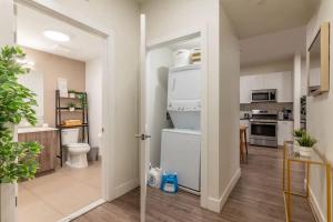 a kitchen with a washer and dryer at Blue Breakaway with Free Parking and Sleeps 9, Book 7 days, Get 20 Percent OFF in East Orange