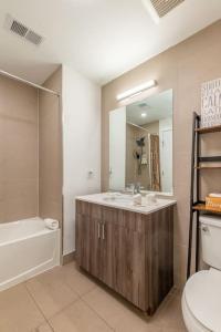 a bathroom with a sink and a toilet and a mirror at Blue Breakaway with Free Parking and Sleeps 9, Book 7 days, Get 20 Percent OFF in East Orange