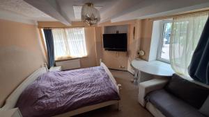 a small room with a bed and a desk at Apartments Londa in Jūrmala
