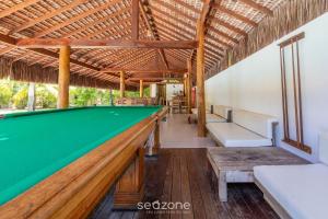 a pool bar in a resort with a pool table at TPZ's - Apartamentos próximos da Praia do Mutá in Porto Seguro