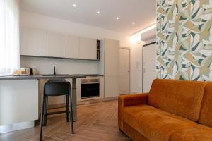 a living room with a couch and a kitchen at MT Apartments in Termoli