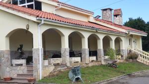 a house with a wheelbarrow in front of it at Casa Rural Villa Ronquillo a 2 k m de las playas in San Pantaleon