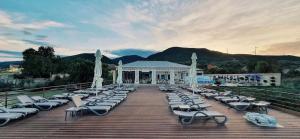 a bunch of lounge chairs sitting on a deck at Pensiunea Elis in Pescari