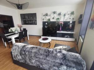 a living room with a couch and a table at Bel Appartement pour 1 à 9 personnes in Ambert