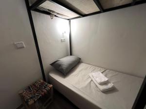 a small bed in a small room with a pillow at Dar Oussama in Rabat