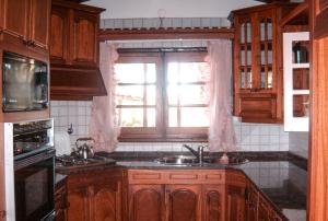 a kitchen with a sink and a window at El Solar de los Pájaros in Merlo