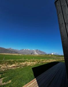 a view of the mountains from the porch of a house at REY Stays - Small & Cozy Studio in Höfn