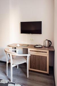 - un bureau avec une télévision et une table avec une chaise dans l'établissement Time Hotel, à Kiev