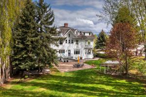 an aerial view of a large white house with a yard at The Gibson Mansion Bed and Breakfast in Missoula