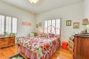 a bedroom with a bed and a dresser and windows at 2 Mi to Dtwn Phoenix Getaway with Patio in Phoenix