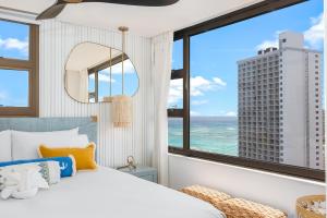 a bedroom with a large window with a view of the ocean at 30th Fl Luxury Ocean & Waikiki view with Free Parking in Honolulu +78 photos