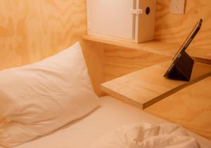 沙由利達的住宿－Casa Pepe，一张带枕头的床和一张桌子上的笔记本电脑