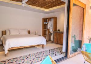 a bedroom with a bed and a sliding glass door at Casa Pepe in Sayulita