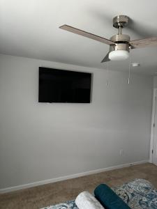 a living room with a flat screen tv on a white wall at QuickRoute Comfort Relax Living in McDonough