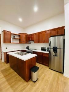 a kitchen with wooden cabinets and a stainless steel refrigerator at Casa Nefertari I in Flores