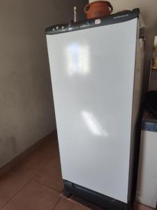 a white refrigerator freezer sitting in a kitchen at La Casita de Seclantás in Seclantás