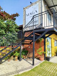a staircase in front of a building with a sign at Maga hospedagem in Penha