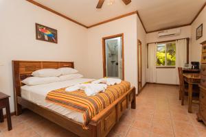 a bedroom with a bed with towels on it at Falling Leaves Lodge in San Ignacio +52 photos