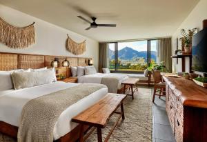 a hotel room with two beds and a large window at 1 Hotel Hanalei Bay in Princeville
