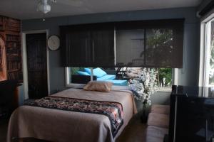 a bedroom with a bed and a large window at Suite DW Batopilas in Tijuana