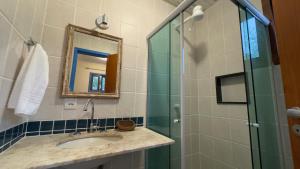 ブジオスにあるPousada Peninsula de Buziosのバスルーム(洗面台、ガラス張りのシャワー付)