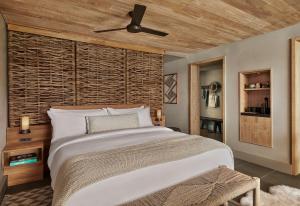 a bedroom with a large bed and a ceiling fan at 1 Hotel Hanalei Bay in Princeville