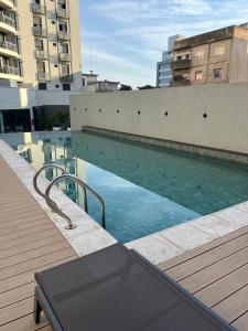 a swimming pool on the roof of a building at Premium tower apart con parking privado Gratis in Córdoba