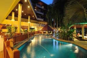 a swimming pool in a building with a hotel at Bauman Grand in Patong Beach