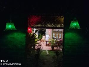 una casa con luci verdi al buio di Nature World Udawalawe a Udawalawe