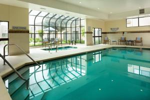 a swimming pool with blue water in a building at Courtyard by Marriott Fort Collins in Fort Collins