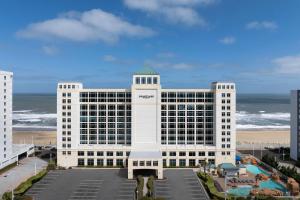 a large white building next to the beach at Courtyard Virginia Beach Oceanfront / North 37th Street in Virginia Beach